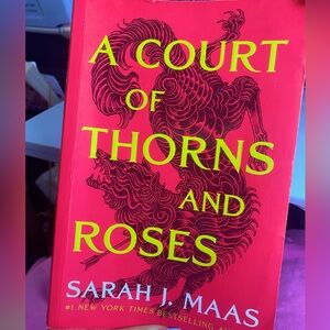 A COURT OF THORNS AND ROSES by: Sarah j. Mass